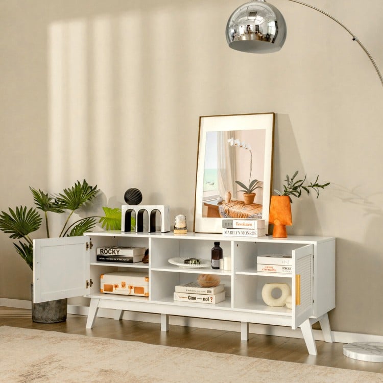 Mid-century modern white TV stand with rattan cabinets and open shelves, perfect for organizing entertainment equipment.
